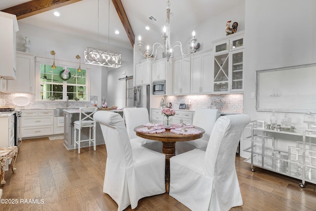 403 Catalina Ln, Youngsville, LA 70592 - dining space with beam ceiling, light wood-style floors, and recessed lighting