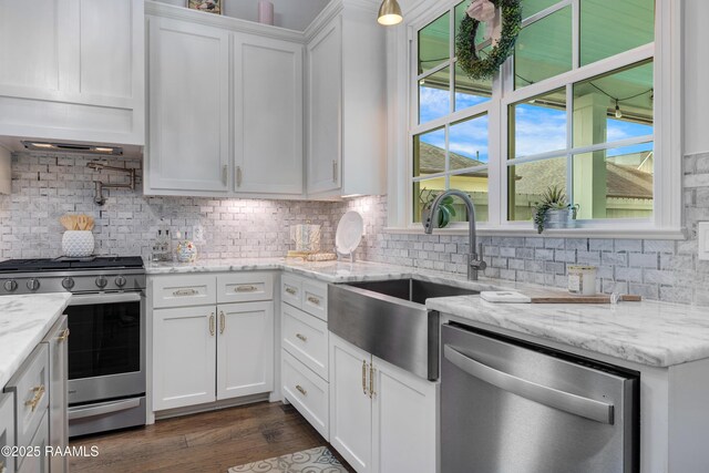 403 Catalina Ln, Youngsville, LA 70592 - kitchen with appliances with stainless steel finishes, white cabinetry, tasteful backsplash, and dark wood-style floors