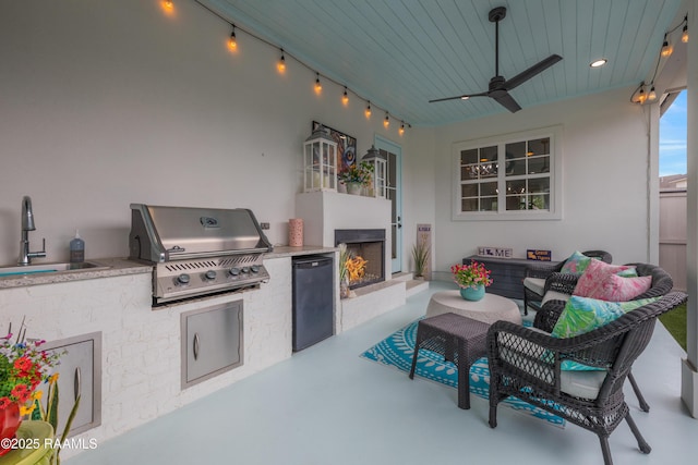 403 Catalina Ln, Youngsville, LA 70592 - view of patio / terrace with an outdoor living space with a fireplace, an outdoor kitchen, and a ceiling fan