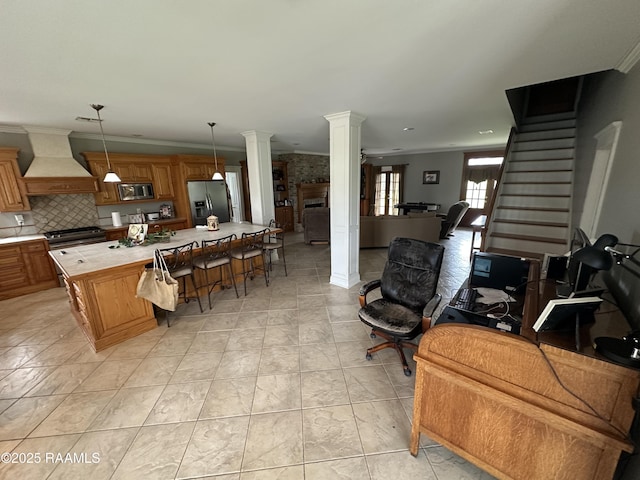 14439 Gladu Rd, Kaplan, LA 70548 - kitchen with custom range hood, decorative columns, stainless steel appliances, ornamental molding, and open floor plan