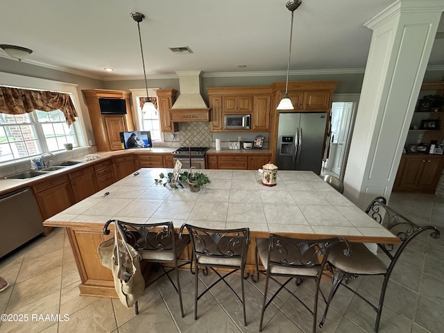14439 Gladu Rd, Kaplan, LA 70548 - kitchen with appliances with stainless steel finishes, custom exhaust hood, tile counters, a center island, and backsplash