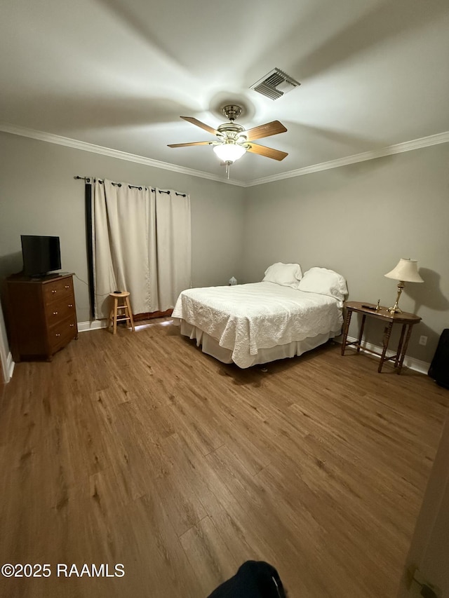 14439 Gladu Rd, Kaplan, LA 70548 - bedroom with crown molding, wood finished floors, and a ceiling fan
