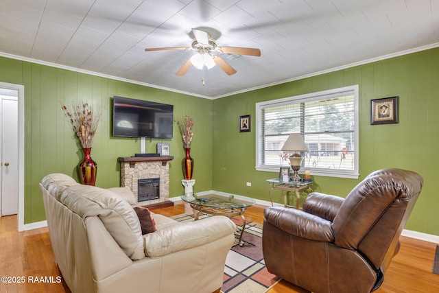 522 Caroline St, New Iberia, LA 70560 - living area with ornamental molding, wood finished floors, a fireplace, a ceiling fan, and a baseboard radiator