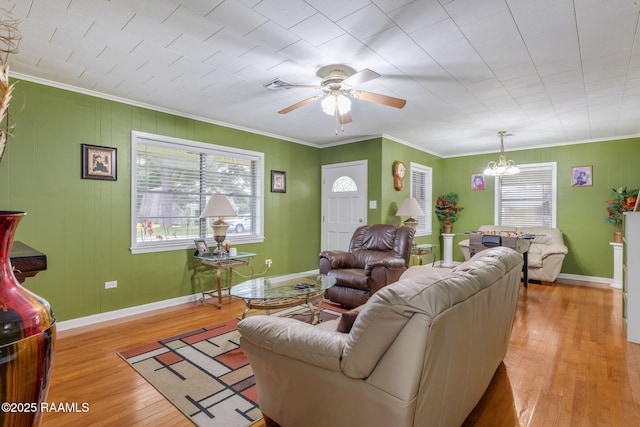 522 Caroline St, New Iberia, LA 70560 - living area featuring a ceiling fan, a chandelier, light wood-style flooring, and ornamental molding