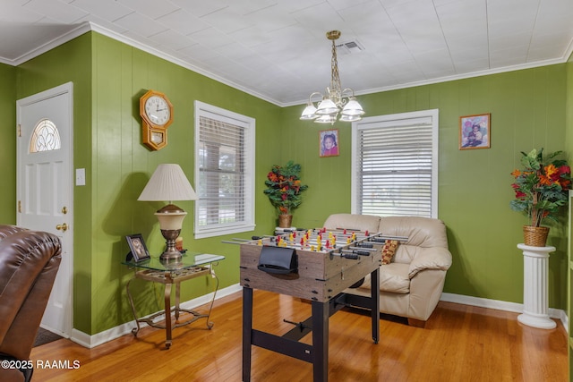 522 Caroline St, New Iberia, LA 70560 - dining room with ornamental molding, healthy amount of natural light, wood finished floors, and a chandelier