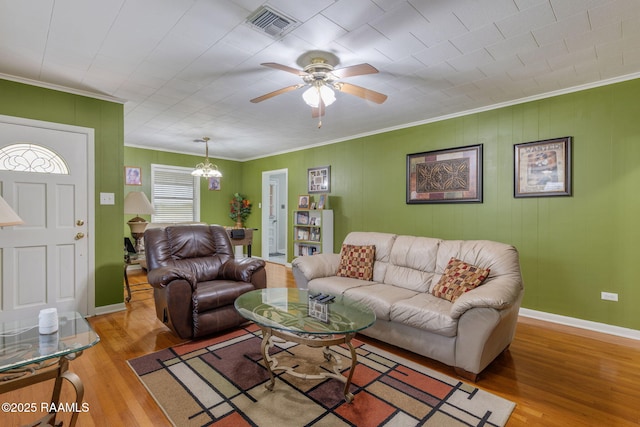 522 Caroline St, New Iberia, LA 70560 - living room with ornamental molding, wood finished floors, a ceiling fan, and a chandelier