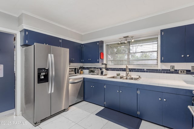522 Caroline St, New Iberia, LA 70560 - kitchen featuring stainless steel appliances, blue cabinetry, light countertops, light marble finish floors, and ornamental molding