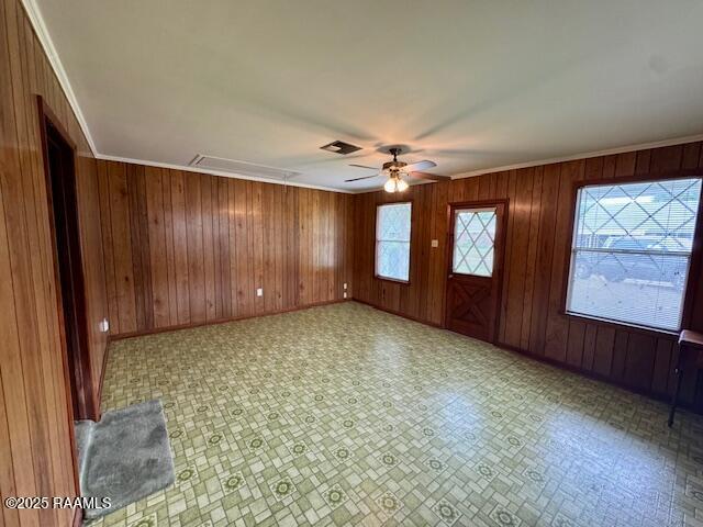 110 W Tampico St, New Iberia, LA 70563 - foyer entrance featuring wooden walls, a ceiling fan, and crown molding