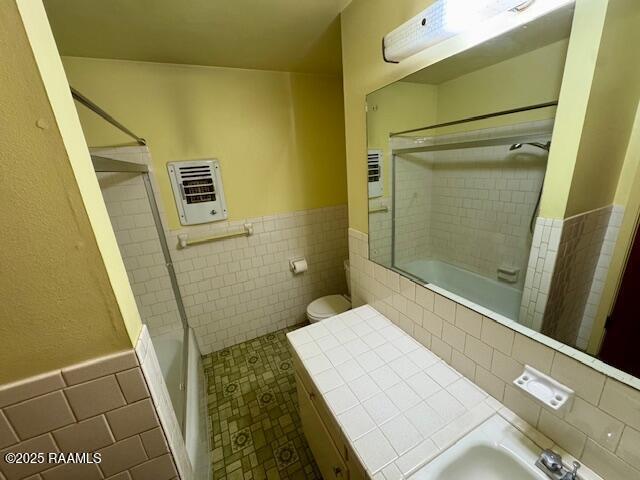 110 W Tampico St, New Iberia, LA 70563 - bathroom featuring  shower combination, tile walls, heating unit, a wainscoted wall, and tile patterned floors