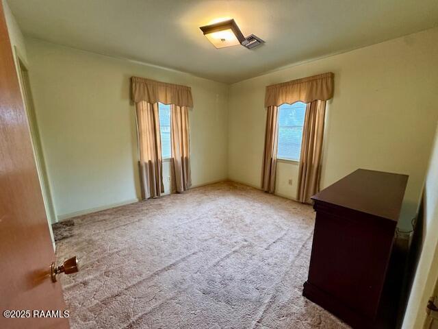 110 W Tampico St, New Iberia, LA 70563 - carpeted spare room with plenty of natural light