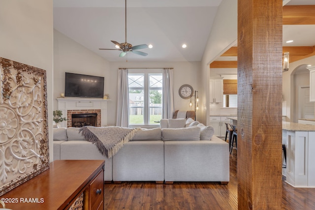 203 Whispering Meadows Rd, Broussard, LA 70518 - living area featuring a ceiling fan, dark wood-style floors, lofted ceiling, a fireplace, and arched walkways