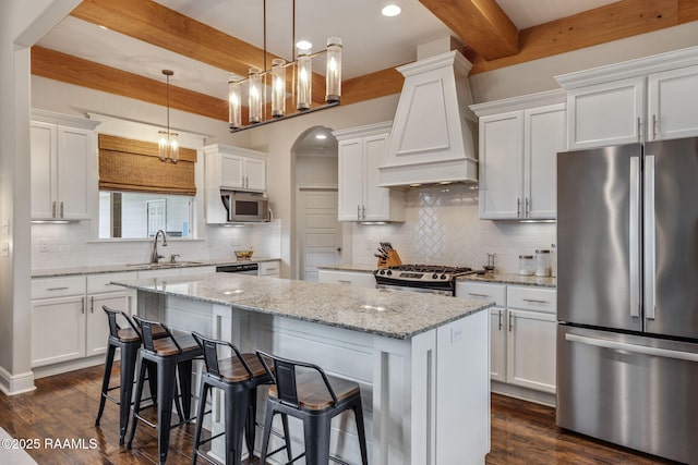 203 Whispering Meadows Rd, Broussard, LA 70518 - kitchen featuring stainless steel appliances, beamed ceiling, custom range hood, a center island, and dark wood finished floors