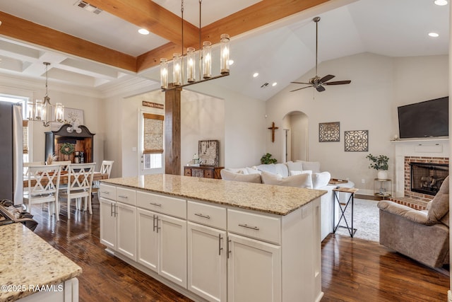 203 Whispering Meadows Rd, Broussard, LA 70518 - kitchen with open floor plan, arched walkways, a fireplace, ceiling fan, and a kitchen island