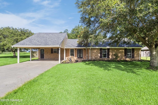 13723 Lynnedale Loop, Abbeville, LA 70510 - ranch-style home featuring french doors, a front lawn, concrete driveway, an attached carport, and a shingled roof