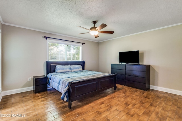 13723 Lynnedale Loop, Abbeville, LA 70510 - bedroom with light wood-type flooring, crown molding, a textured ceiling, and a ceiling fan