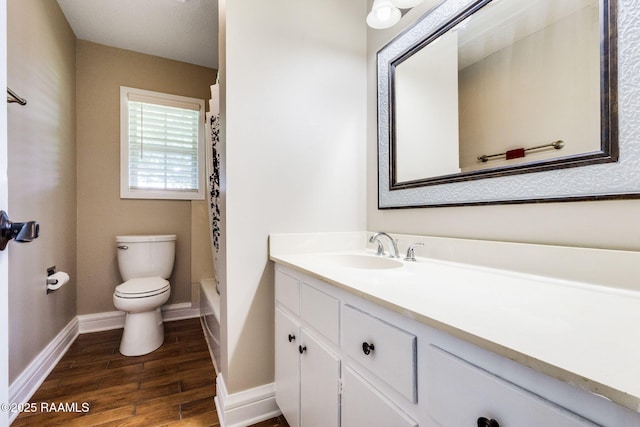 13723 Lynnedale Loop, Abbeville, LA 70510 - bathroom featuring vanity, wood finished floors, and shower / bath combo