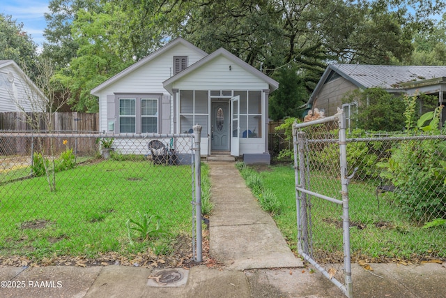 610 Ashton St, New Iberia, LA 70563 - view of front of property featuring a gate, a sunroom, and a fenced front yard
