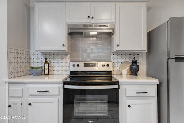 610 Ashton St, New Iberia, LA 70563 - kitchen featuring appliances with stainless steel finishes, under cabinet range hood, white cabinetry, light countertops, and decorative backsplash