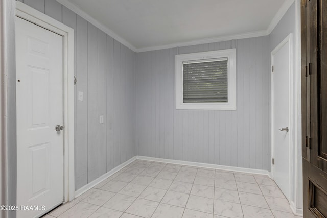 610 Ashton St, New Iberia, LA 70563 - unfurnished room featuring light marble finish flooring, crown molding, and wood walls