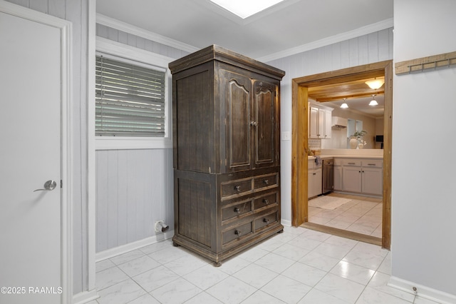 610 Ashton St, New Iberia, LA 70563 - corridor with wood walls, crown molding, and light marble finish floors