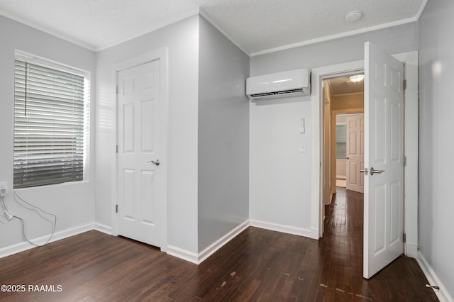 610 Ashton St, New Iberia, LA 70563 - unfurnished bedroom with an AC wall unit and dark wood finished floors