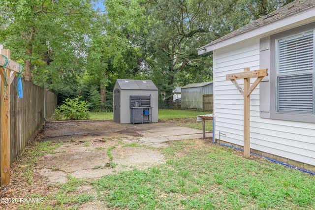 610 Ashton St, New Iberia, LA 70563 - view of yard featuring a storage unit and view of wooded area