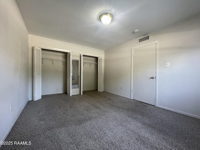 3121 Johnston St Apt 139, Lafayette, LA 70503 - unfurnished bedroom featuring multiple closets and carpet flooring