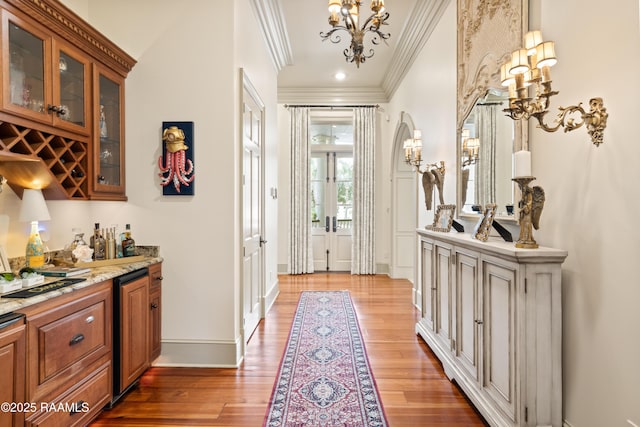 232 Princeton Woods Loop, Lafayette, LA 70508 - entrance foyer with crown molding, a chandelier, light wood-type flooring, arched walkways, and french doors
