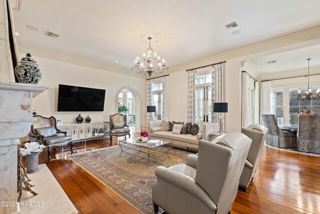 232 Princeton Woods Loop, Lafayette, LA 70508 - living room featuring a chandelier, hardwood / wood-style flooring, and ornamental molding