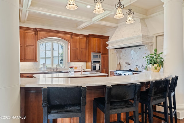232 Princeton Woods Loop, Lafayette, LA 70508 - kitchen featuring appliances with stainless steel finishes, coffered ceiling, light countertops, custom range hood, and beam ceiling