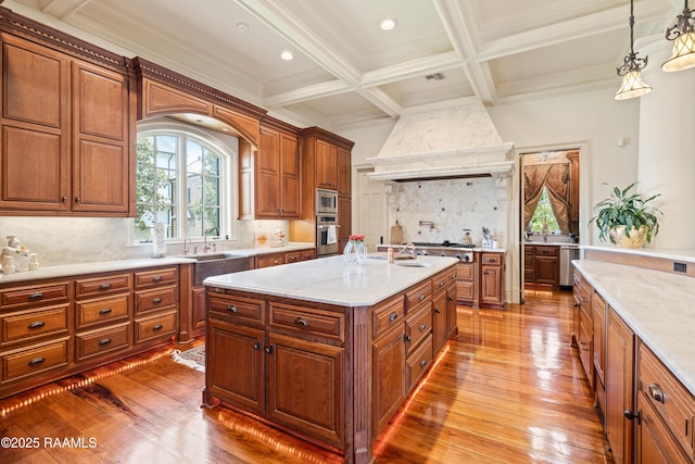232 Princeton Woods Loop, Lafayette, LA 70508 - kitchen featuring hardwood / wood-style floors, crown molding, brown cabinets, beam ceiling, and backsplash