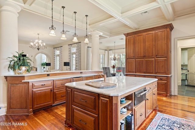 232 Princeton Woods Loop, Lafayette, LA 70508 - kitchen with a chandelier, a warming drawer, ornate columns, crown molding, and an island with sink