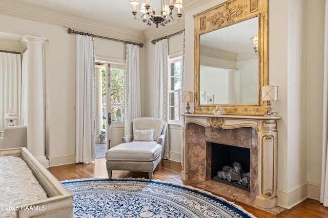 232 Princeton Woods Loop, Lafayette, LA 70508 - sitting room featuring wood finished floors, a chandelier, ornamental molding, and a premium fireplace