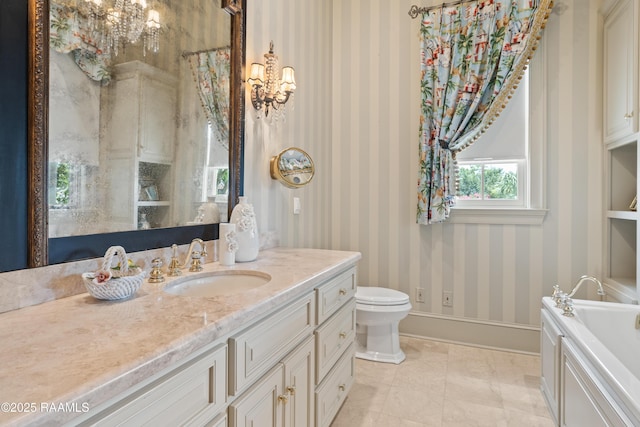 232 Princeton Woods Loop, Lafayette, LA 70508 - full bathroom featuring wallpapered walls, a chandelier, vanity, and a garden tub