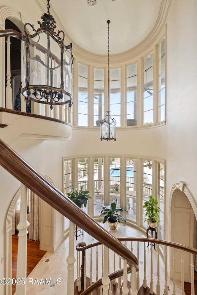 232 Princeton Woods Loop, Lafayette, LA 70508 - stairway featuring a chandelier, a high ceiling, and wood finished floors