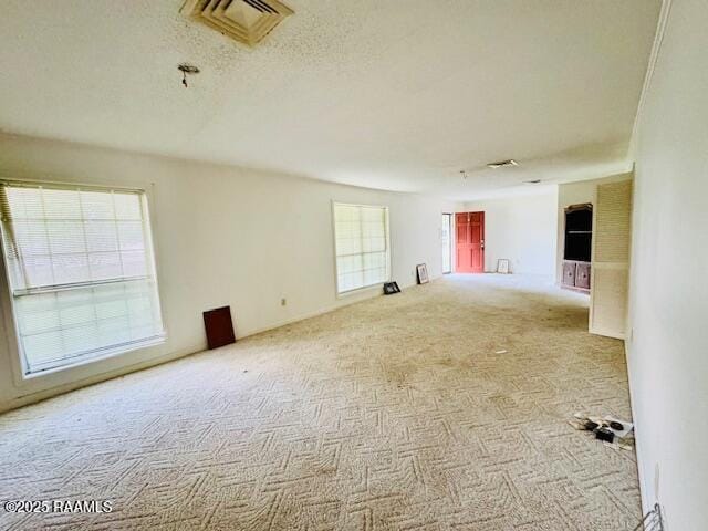 122 Progress Rd, Ville Platte, LA 70586 - carpeted spare room featuring a textured ceiling
