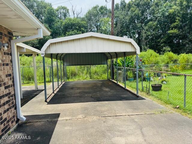 122 Progress Rd, Ville Platte, LA 70586 - view of parking / parking lot featuring a detached carport and driveway