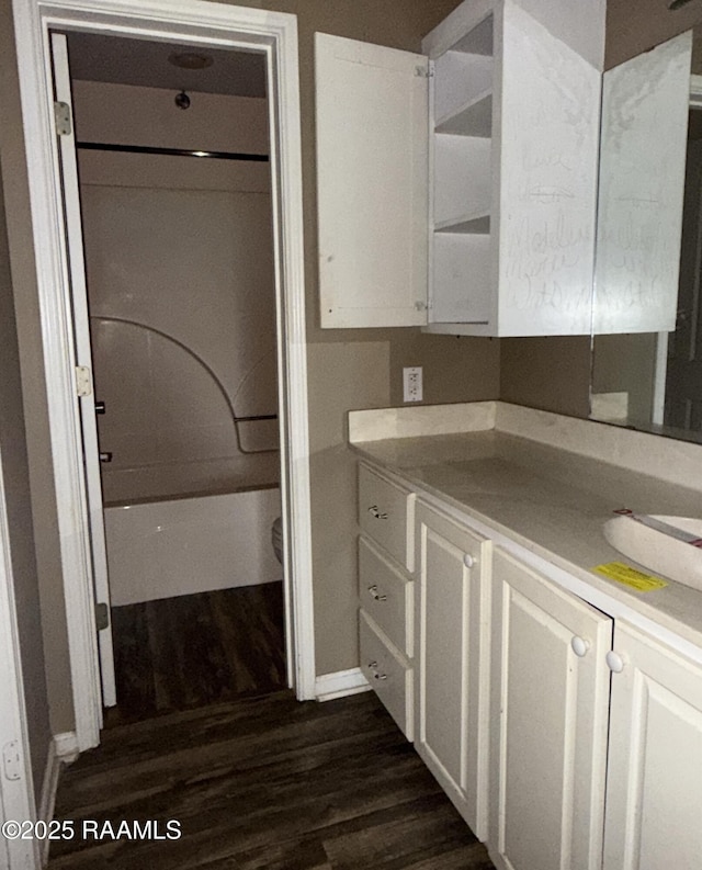 14927 S Guegnon St, Abbeville, LA 70510 - kitchen with dark wood-type flooring, open shelves, white cabinetry, and light countertops