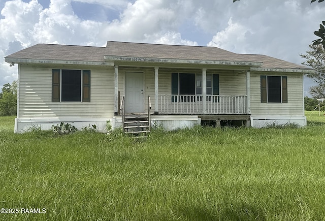 14927 S Guegnon St, Abbeville, LA 70510 - view of front of home with covered porch and a front lawn