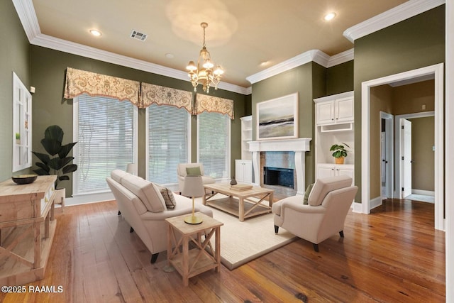 100 Carrollton Cir, Lafayette, LA 70503 - living area featuring a chandelier, hardwood / wood-style floors, a premium fireplace, crown molding, and recessed lighting