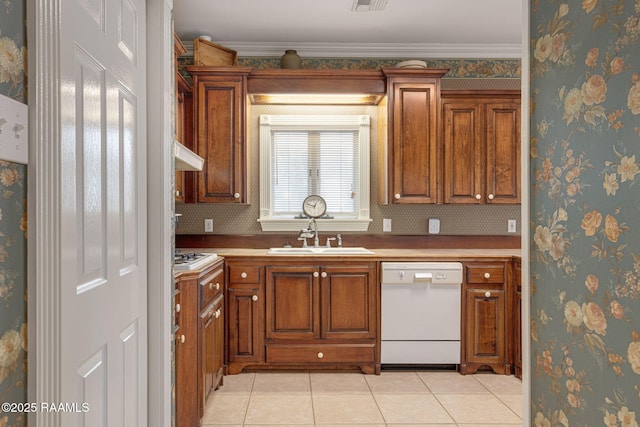 104 Briarfield Dr, Carencro, LA 70520 - kitchen with dishwasher, brown cabinetry, light tile patterned flooring, and under cabinet range hood