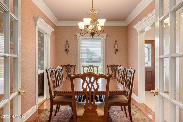 104 Briarfield Dr, Carencro, LA 70520 - dining space featuring light wood-style flooring, a chandelier, ornamental molding, and wallpapered walls