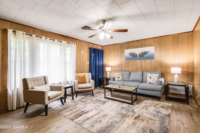 107 Julenie Way, Youngsville, LA 70592 - living room featuring a ceiling fan, wood finished floors, and wood walls