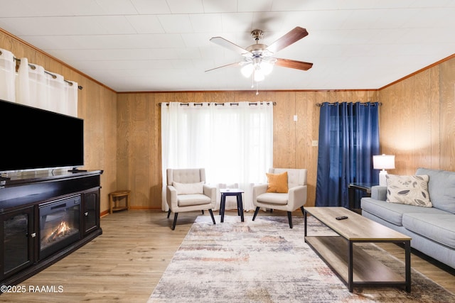 107 Julenie Way, Youngsville, LA 70592 - living area featuring wood walls, a ceiling fan, and light wood finished floors