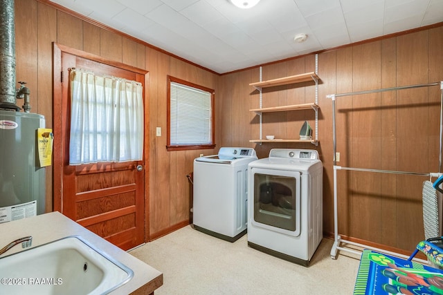 107 Julenie Way, Youngsville, LA 70592 - laundry area featuring gas water heater, wooden walls, washing machine and dryer, light carpet, and ornamental molding