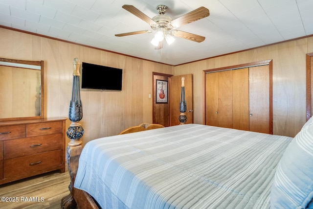 107 Julenie Way, Youngsville, LA 70592 - bedroom with wood finished floors, ornamental molding, a closet, wood walls, and ceiling fan