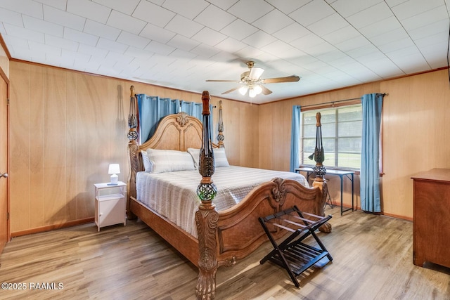107 Julenie Way, Youngsville, LA 70592 - bedroom with light wood-style floors, a ceiling fan, and wooden walls
