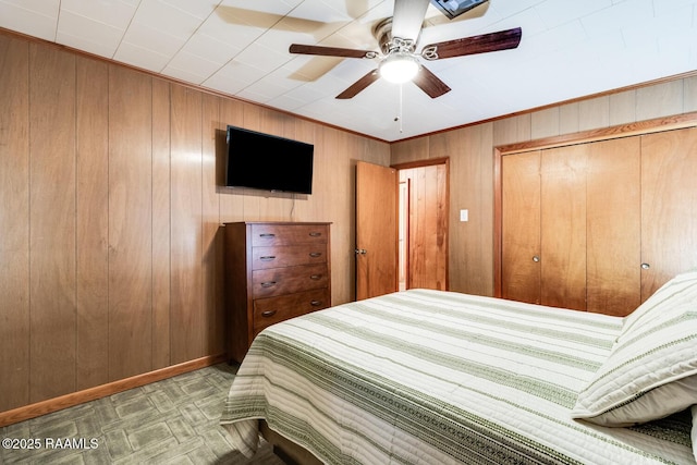 107 Julenie Way, Youngsville, LA 70592 - bedroom featuring wood walls, a closet, and a ceiling fan