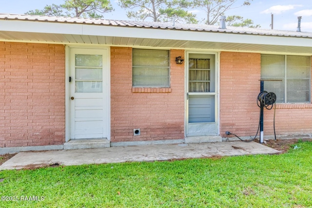 107 Julenie Way, Youngsville, LA 70592 - entrance to property with a lawn and brick siding