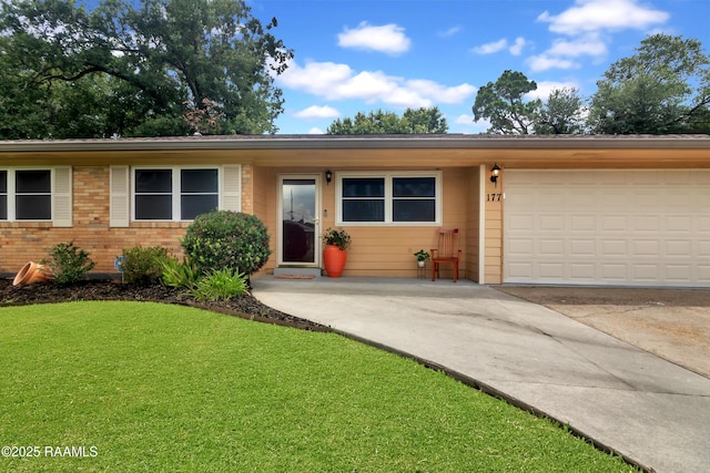 177 Radcliffe Dr, Lafayette, LA 70501 - ranch-style house with driveway, a garage, a front yard, and brick siding